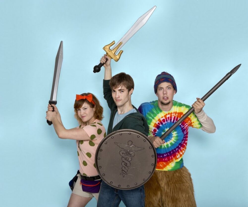 The three main characters from the Lightning Thief stand with their weapons