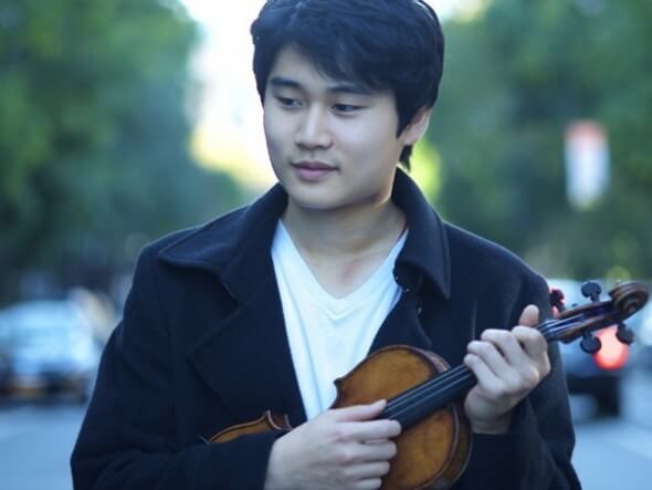 Violinist In Mo Yang holds his instrument