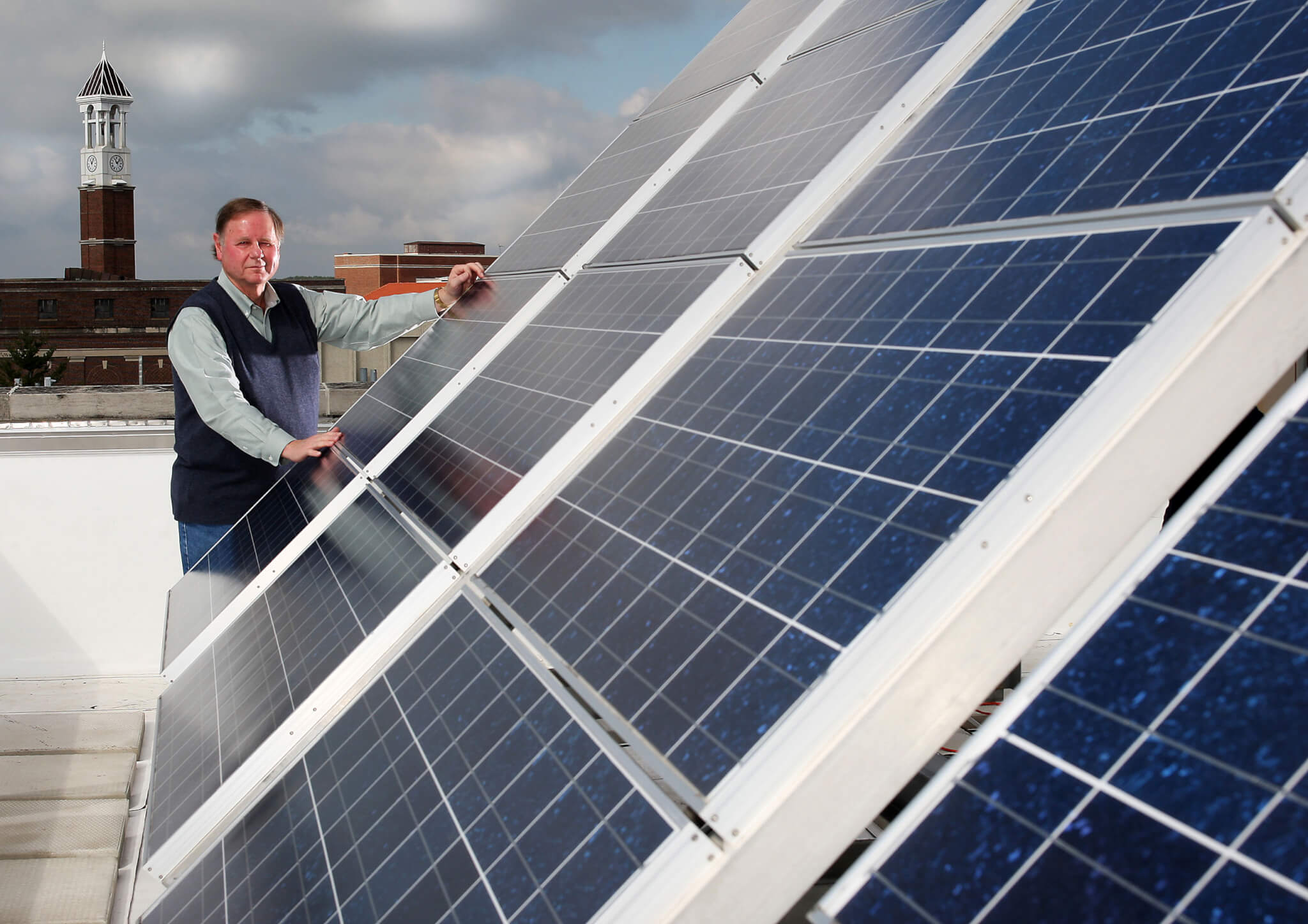 Wally Tyner standing next to photovoltaic array at Purdue