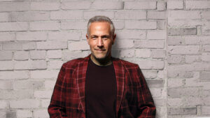 Jim Brickman against brick wall