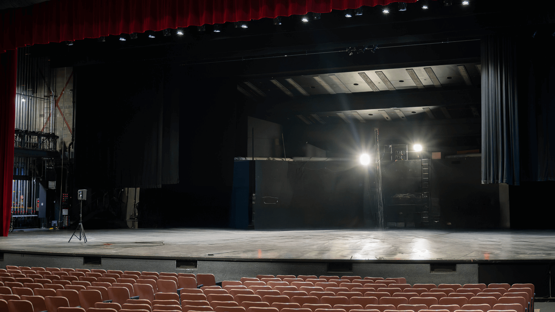 Elliott Hall of Music stage shown empty with the work lights shining down