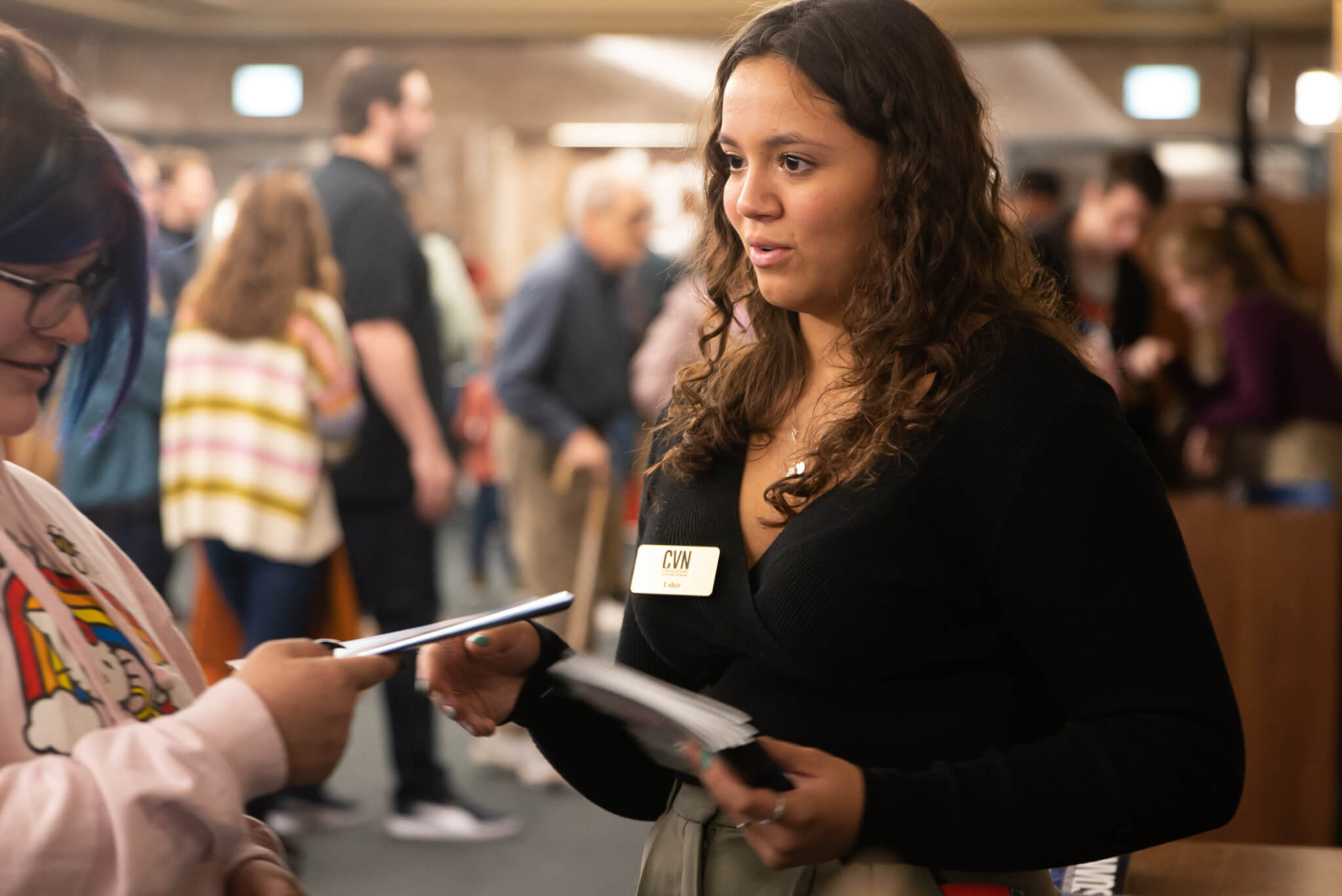 A student ushers a patron into Elliott Hall of Music
