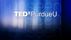 The TEDxPurdueU logo shines on a blue abstract background, with "Unseen" echoed in large, subtle text behind. Below the logo: x = independently organized TED event.