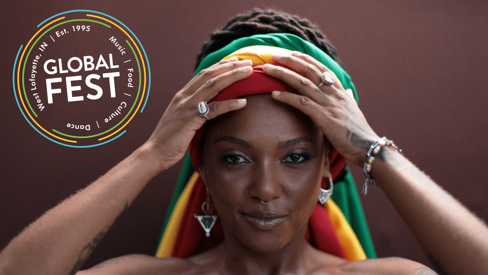 A woman wearing a colorful headwrap and jewelry looks directly at the camera. Next to her is a circular logo for the 30th Annual West Lafayette Global Fest, featuring text about music, food, culture, and dance in West Lafayette, IN.
