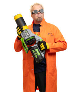 A person in an orange lab coat and black goggles holds a large, futuristic toy blaster. They have spiky blond hair and wear yellow gloves, standing against a white background.