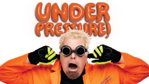 A man with spiky blond hair, goggles, and gloves covers his ears and looks surprised. He wears an orange lab coat. Above him, large orange text reads UNDER PRESSURE!.